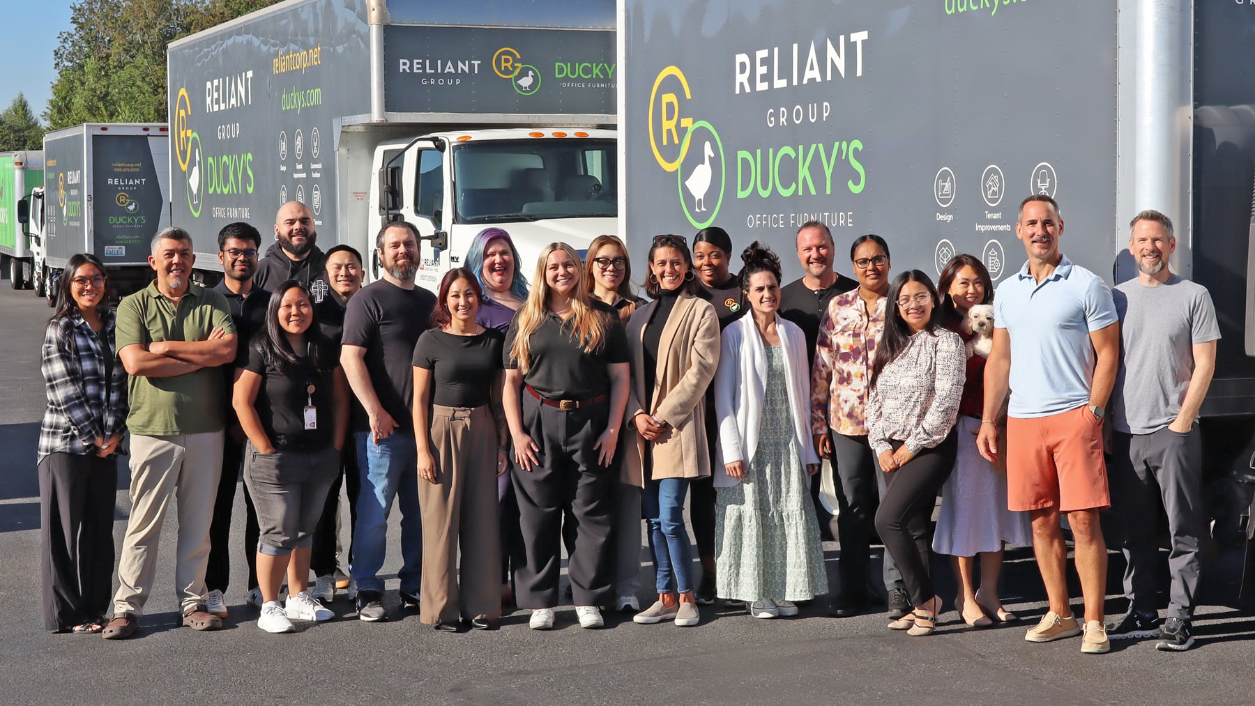 The Reliant Group team in front of the company truck fleet