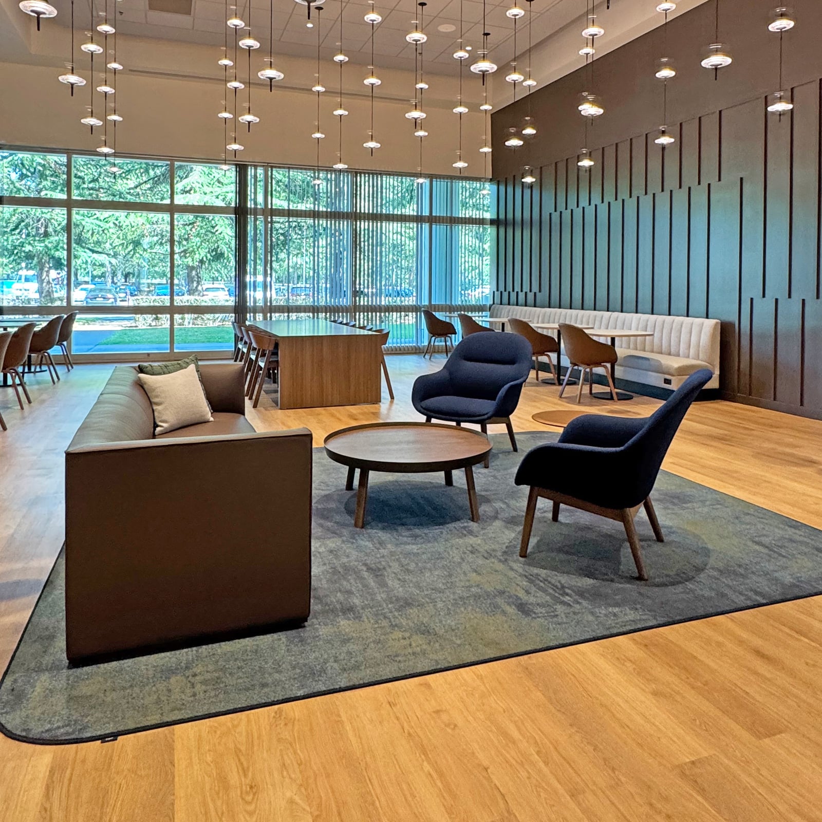 Workplace cafe and lounge with banquette seating and communal tables
